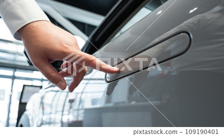A man opens a car door with a fingerprint. Integrated handle. A man opens a car door with a fingerprint. Integrated handle. 109190401