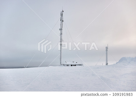 Transmitter towers on a hill in winter 109191983