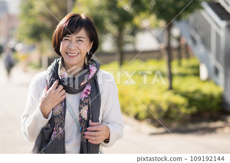 A woman in her 50s walking in a residential area A woman in her 50s walking in a residential area 109192144