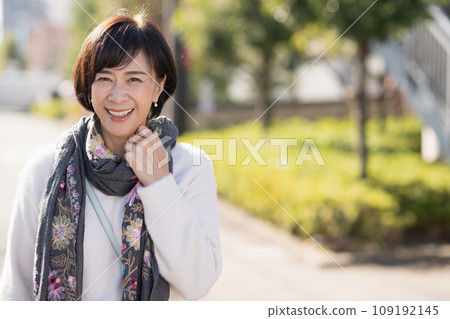 A woman in her 50s walking in a residential area A woman in her 50s walking in a residential area 109192145