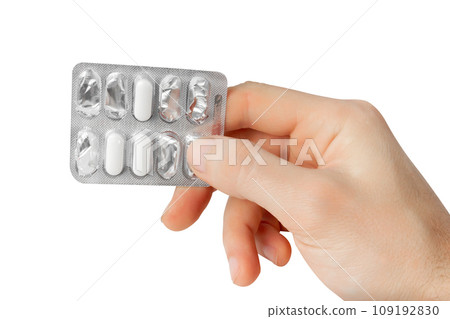 Blister with tablets in hands. Isolate on a white background. Blister with tablets in hands. Isolate on a white background. 109192830