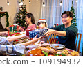 Happy asian people are celebrating on a table meal when christmas and new year at home. 109194932