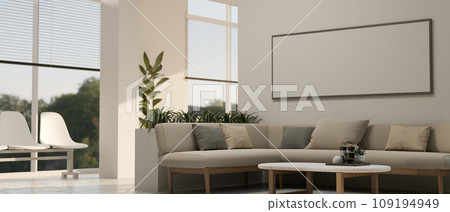 Interior design of a modern waiting area lounge with a cosy couch, a coffee table, and decor. 109194949