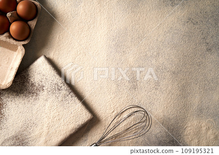 Baking background with flour,cutting board, eggs on a table, flat lay photo view. Baking background with flour,cutting board, eggs on a table, flat lay photo view. 109195321