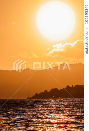 Beautiful sunset on the coast of the Aegean Sea with mountains and boats. Summer vacation and coastal nature concept 109195343