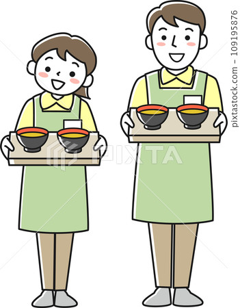 Male and female facility staff serving meals while wearing aprons 109195876
