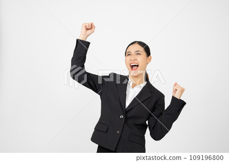 Happy young businesswoman in black outfit with white isolated background. Celebrating pose. 109196800