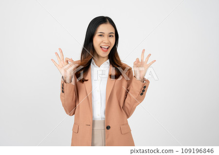 Portrait happy Asian woman shows ok hand sign and looking at the camera on white isolated background 109196846