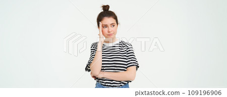 Portrait of concerned, worried young woman, touches her head, looking complicated, standing over white background 109196906