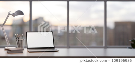 Mock up laptop computer on a table in minimal modern living room. Home workspace, closeup image Mock up laptop computer on a table in minimal modern living room. Home workspace, closeup image 109196986