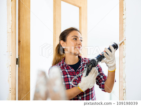 Cheerful woman using spray foam 109198039
