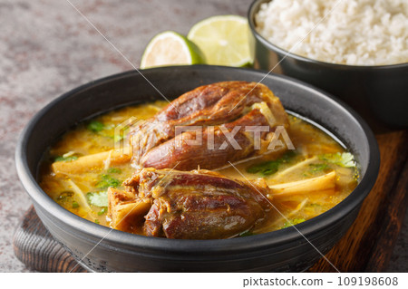 Nihari Pakistani lamb Shank Stew is a traditional slow-cooked one-pot meal made with meat in spicy gravy closeup on the wooden board. Horizontal Nihari Pakistani lamb Shank Stew is a traditional slow-cooked one-pot meal made with meat in spicy gravy closeup on the wooden board. Horizontal 109198608
