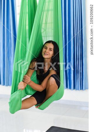 Young woman making aerial or fly yoga pose 109200662