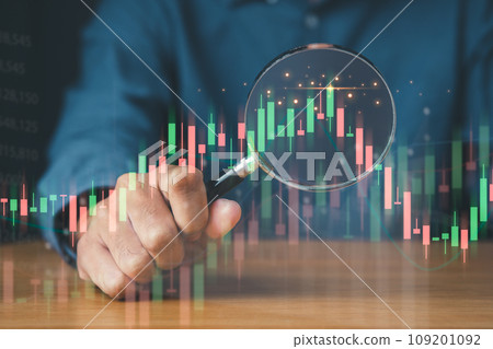 Businessman using magnifier focus on financial graph for business investment growth and money concept. 109201092