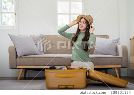 Beauty asian traveler woman packing prepare stuff and outfit clothes in suitcase travel bag luggage for holidays at home, weekend, tourist, journey Beauty asian traveler woman packing prepare stuff and outfit clothes in suitcase travel bag luggage for holidays at home, weekend, tourist, journey 109201154