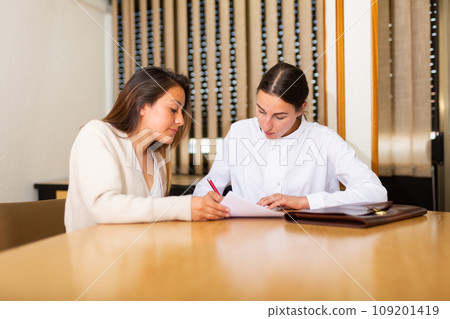 Woman signing apply for job agreement sitting at office Woman signing apply for job agreement sitting at office 109201419