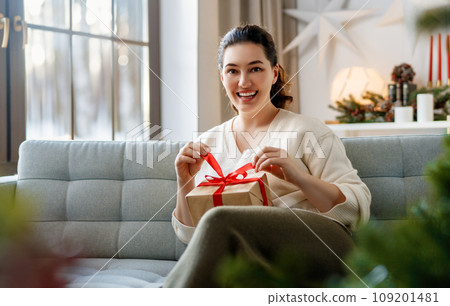 woman with Christmas present woman with Christmas present 109201481