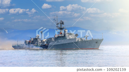 Russian warship going along the coast of Pacific ocean on soft sunlight 109202139