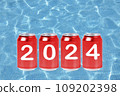 2024, Red soda cans with the number 2024 on background of faded lights. Happy New Year 109202398