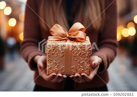 Close up of crop female holding present box during christmas celebration.Created with Generative AI technology. 109202881