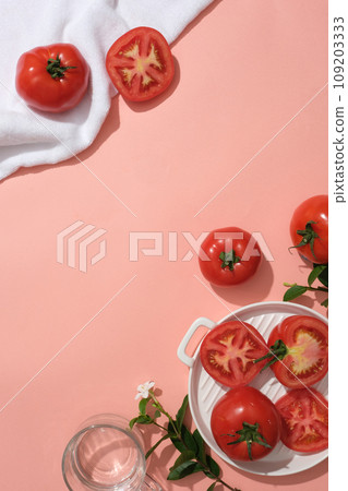 Creative scene for advertising natural ingredient with tomato. Pink background with copy space. Tomatoes bring many health benefits, high nutritional content and help the body fight many diseases. Creative scene for advertising natural ingredient with tomato. Pink background with copy space. Tomatoes bring many health benefits, high nutritional content and help the body fight many diseases. 109203333
