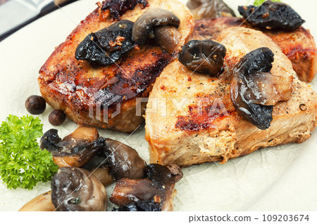 Meat medallions with mushrooms. Meat medallions with mushrooms. 109203674