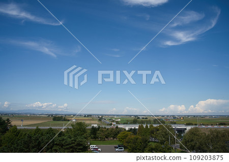 Rural scenery and blue sky in Hokkaido in summer, seen from the observation deck of the roadside station Maoi no Oka Park Rural scenery and blue sky in Hokkaido in summer, seen from the observation deck of the roadside station Maoi no Oka Park 109203875