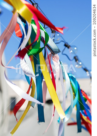 Colorful ribbons on rope on background of blue sky Colorful ribbons on rope on background of blue sky 109204634