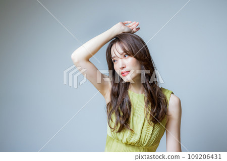 A woman wearing a yellow-green dress 109206431