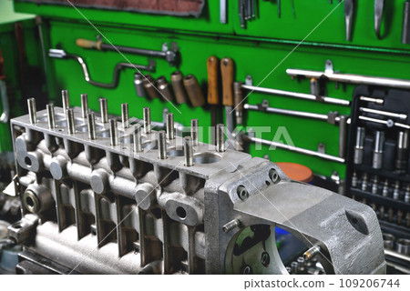 car fuel pump repair, truck fuel pump housing on workbench in service, repair tools and workbench in workshop, truck service, selective focus car fuel pump repair, truck fuel pump housing on workbench in service, repair tools and workbench in workshop, truck service, selective focus 109206744