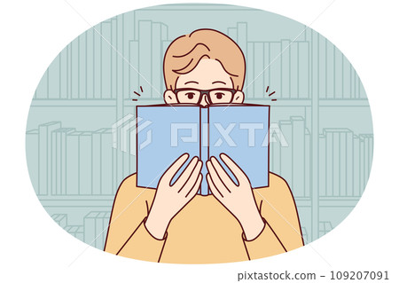 Man in glasses reading book in library Man in glasses reading book in library 109207091