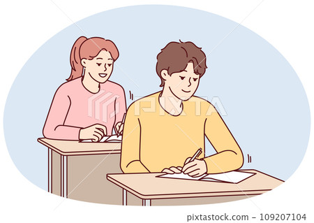 Smiling students sit at desk writing at lesson Smiling students sit at desk writing at lesson 109207104