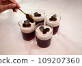 Delicious milk and berry jelly in a glass on the table 109207360