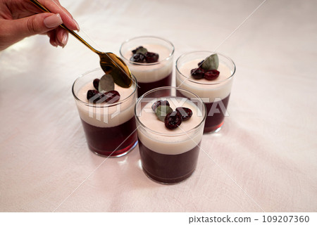 Delicious milk and berry jelly in a glass on the table 109207360