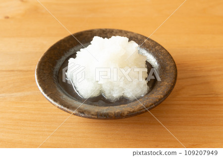Grated radish on a small plate 109207949