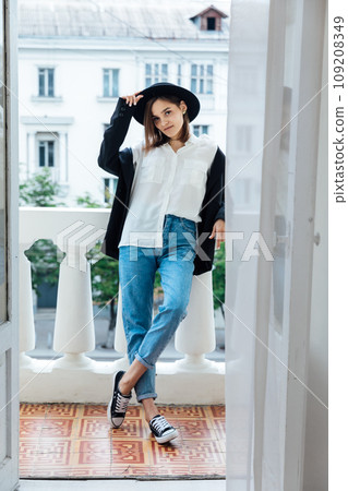 Woman in a hat on the balcony in the apartment Woman in a hat on the balcony in the apartment 109208349