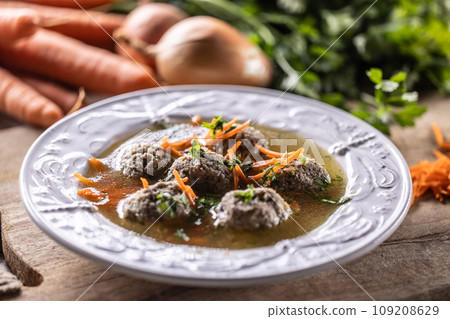 Broth with liver dumplings made from beef liver bread eggs and parsley cooked in beef broth. 109208629