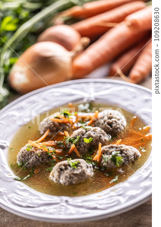 Broth with liver dumplings made from beef liver bread eggs and parsley cooked in beef broth. Broth with liver dumplings made from beef liver bread eggs and parsley cooked in beef broth. 109208630