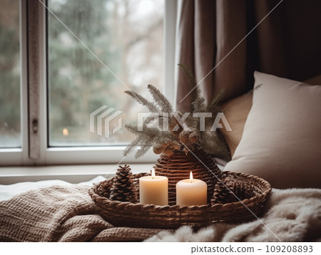 Decorative winter arrangement with fir and candles in cozy home interior, stylish room decor for Christmas holiday season, afternoon daylight 109208893