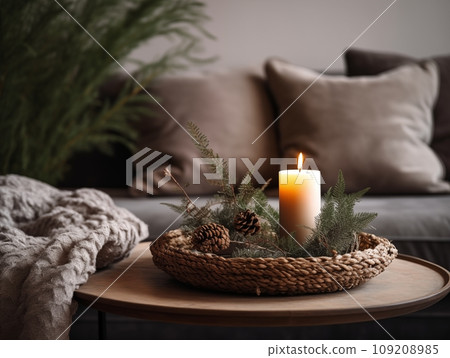 Decorative winter arrangement with fir and candles in cozy home interior, stylish room decor for Christmas holiday season, afternoon daylight 109208985