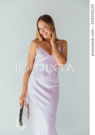 Beautiful slender fashionable woman in summer silk dress Beautiful slender fashionable woman in summer silk dress 109209229