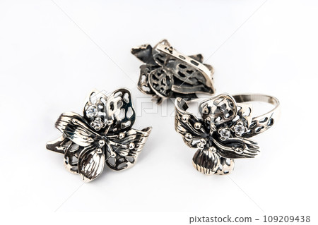 Elegant jewelry set of white gold ring, necklace and earrings with diamonds. Silver jewellery set with gemstones. Product still life concept Elegant jewelry set of white gold ring, necklace and earrings with diamonds. Silver jewellery set with gemstones. Product still life concept 109209438