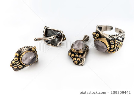 Elegant jewelry set of white gold ring, necklace and earrings with diamonds. Silver jewellery set with gemstones. Product still life concept Elegant jewelry set of white gold ring, necklace and earrings with diamonds. Silver jewellery set with gemstones. Product still life concept 109209441