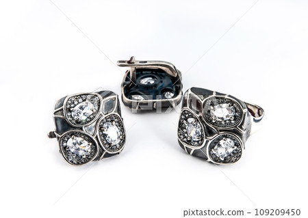 Elegant jewelry set of white gold ring, necklace and earrings with diamonds. Silver jewellery set with gemstones. Product still life concept Elegant jewelry set of white gold ring, necklace and earrings with diamonds. Silver jewellery set with gemstones. Product still life concept 109209450