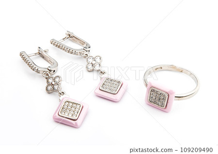 Silver jewelry set of ring and silver earrings with stones on white background. Silver jewelry set collection 109209490