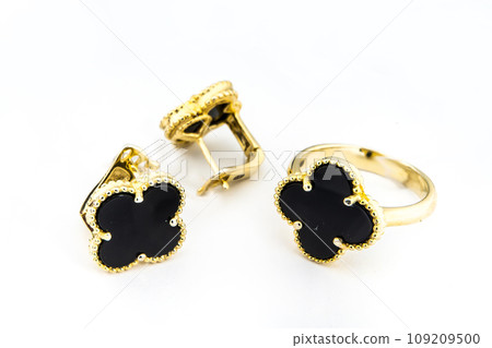 Gold jewelry set of ring and gold earrings with stones on white background. Gold jewelry set collection Gold jewelry set of ring and gold earrings with stones on white background. Gold jewelry set collection 109209500