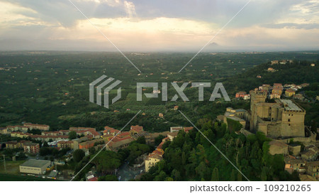 drone view, the sun sets behind the mountain landscape during a beautiful sunset with rays of sunlight drone view, the sun sets behind the mountain landscape during a beautiful sunset with rays of sunlight 109210265