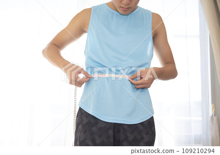 Teenage boy concerned about waist circumference 109210294
