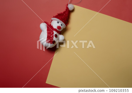 Christmas concept. Snowman on yellow and red background with copy space for text 109210355