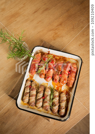 Traditional Christmas dish Sausages wrapped in bacon Traditional Christmas dish Sausages wrapped in bacon 109210409